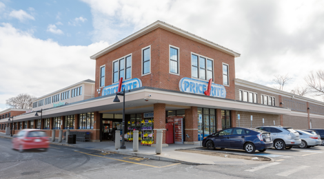 shopping plaza with supermarket and cars parked