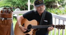 male affordable housing resident playing guitar