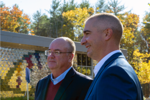 A profile photo of two male leaders of Saco & Biddeford Savings Institution standing outdoor next to each other.