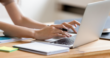 female hands typing on a laptop